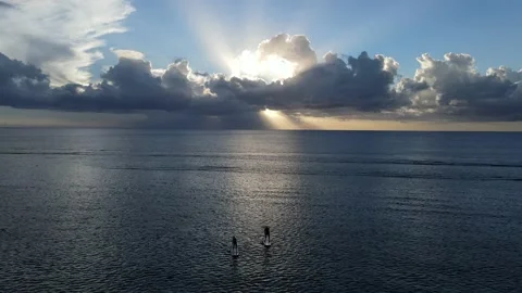 Aerial view of a couple on stand up paddles during the sunset Stock Footage