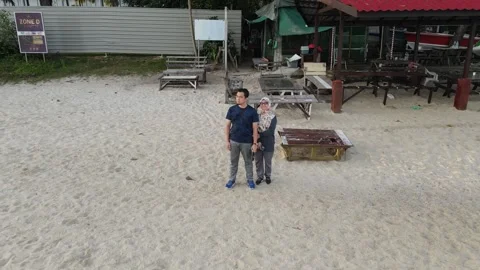 Aerial view of couple standing on beach in Penang Stock Footage 150111064