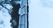 Aerial View Of Couple Walking On Bridge Above Dam In Winter Stock Footage