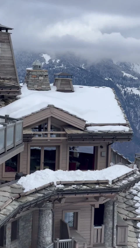 Aerial view of Courchevel by  winter with chalets and hotels in the front Stock Footage 334440400