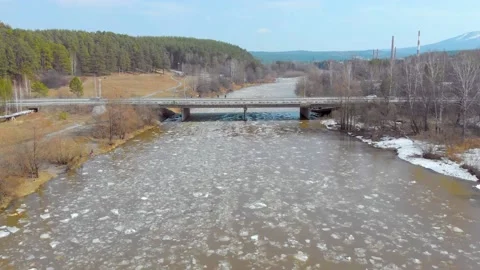 Aerial view of the course of the ice on the river. People stand on the bridge Stock Footage 155710502
