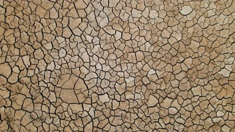 Aerial view of cracked soil ground of dried lake or river Vídeo Stock 235693035
