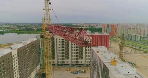 Aerial view of crane and building construction, many cranes on horizon. Drone Video stock 78940877