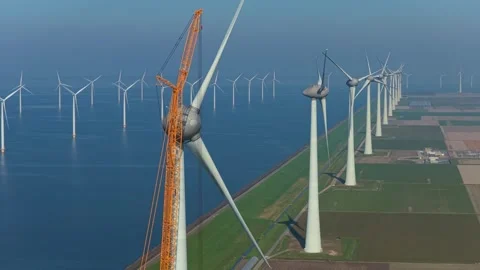 Aerial view of crane constructing wind turbine in netherlands Stock Footage 332850298