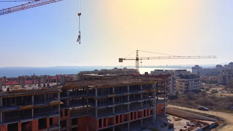 Aerial view of crane hook over coastal construction site, Bulgaria Stock Footage 343848785
