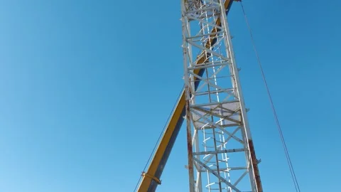 Aerial View: Crane operator climbs high ladders and mounts components with Vídeo Stock 296022061