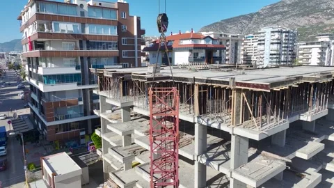 Aerial View: Crane operator mounts large components, navigating ladders like a Vídeo Stock 296021578