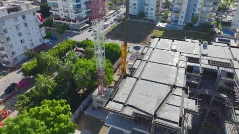 Aerial View: A crane operator mounts parts with precision and climbs ladders Video stock 296021894