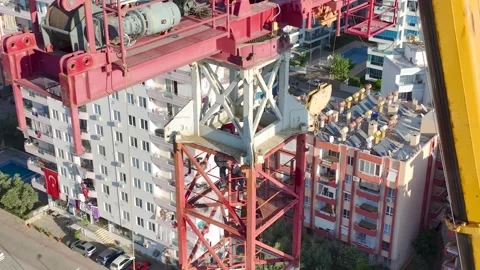 Aerial View: Crane operator mounts parts and scales ladders like a true expert Stock Footage 296024550