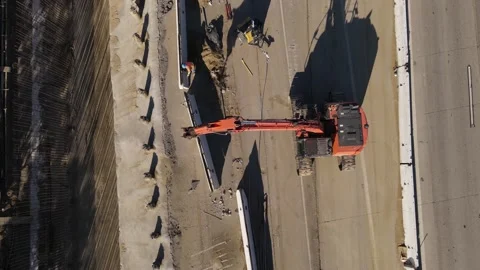Aerial view of crane at work during construction on California's 405 freeway. Stock Footage 164082982