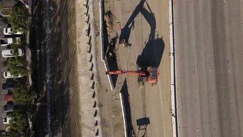 Aerial view of crane at work during construction on California's 405 freeway. Stock-Footage 164083044