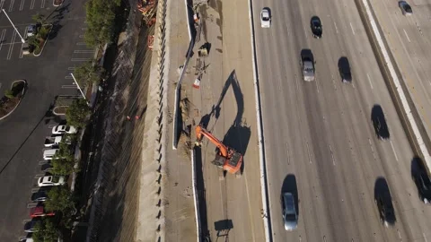 Aerial view of crane at work during construction on California's 405 freeway. Stock-Footage 164084529