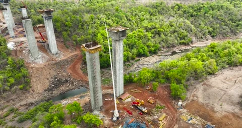 Aerial view cranes and bridge foundation pillars on construction site. Aeri.. Stock Footage 285600780