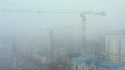 Aerial view of cranes on construction site covered in smog 動画素材 126041441