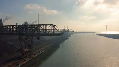 Aerial view. Cranes for loading at an industrial plant standing at sea Stock Footage 98992015