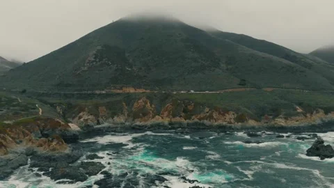 Aerial View of Crashing Ocean Waves Against Rocky Coastline Stock Footage 332321453