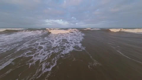 Aerial view of crashing ocean waves with white foam Stock Footage 344672305