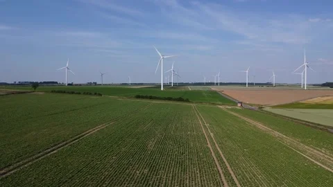 Aerial view crop field approaching wind farm turbine drone Stock Footage 250248830