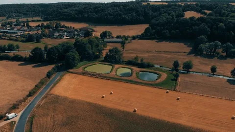 Aerial view of crop wheat or rye field with stook hay straw bales. Three small Stock Footage 93377482