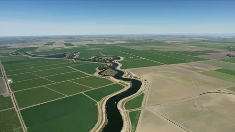 Aerial view crops growing patchwork fields California lowlands Stock Footage 91544680