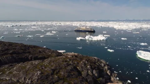 Aerial view of cruise ship navigating icebergs, Greenland. Stock Footage 345004602
