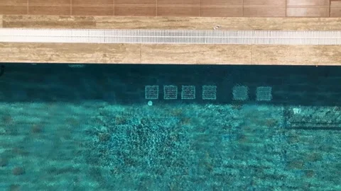 Aerial View: A crystal-clear pool, soothing jacuzzi, and colorful slides make 動画素材 296031217
