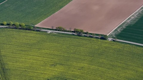 Aerial view of cultivated fields and road, France. 库存影片 332704313
