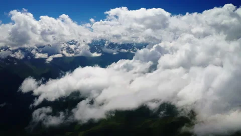 Aerial View of Cumulus Clouds Over Mountain Range. Expansive cloudscape above a Stock Footage 265035248