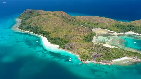 Aerial view of Curieuse island, clear water of Indian Ocean, Praslin, Seychelles Stock Footage 99874010