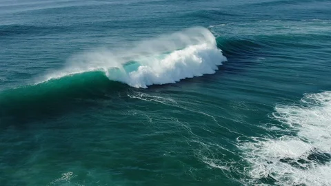 Aerial view of curling ocean waves with splashing wave crest Stock Footage 104945535