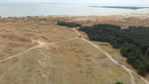Aerial view of the Curonian Spit, Lithuania, featuring sand dunes, pine forest, Video stock 321751053