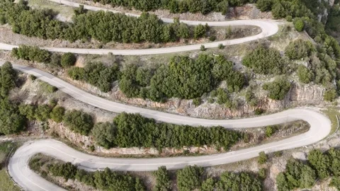 Aerial View of the Curved Road to Papingo Village Surrounded by the Majestic Video stock 307561574