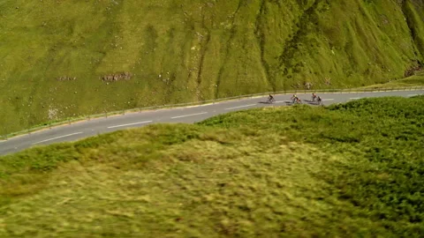 Aerial view of cyclists riding on a mountain road Stock Footage 336804540