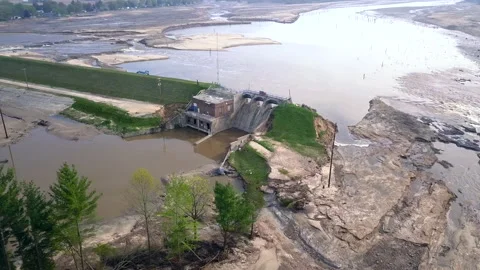Aerial view of dam and draining Wixom Lake in Michigan during flood Stock Footage 131828532
