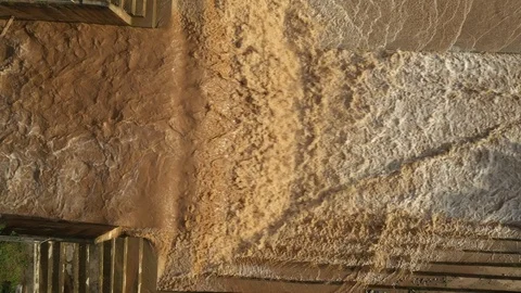 Aerial view of the dam and there is severe water flow Stock Footage 117281069