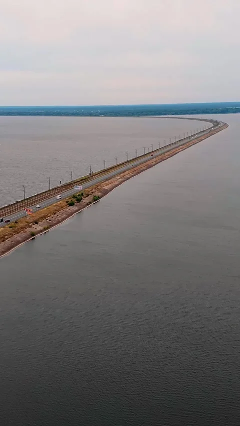 Aerial view. dam with a highway, with active traffic, across the river Stock Footage 321649076