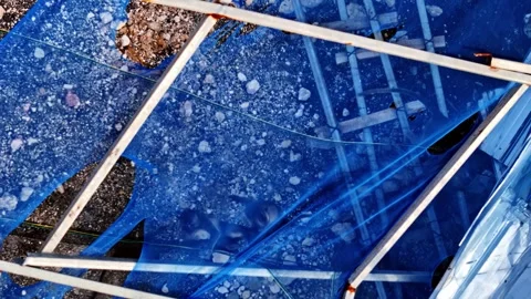 Aerial view of damaged blue shade net at Uluwatu Beach, Indonesia. Stock Footage 345035441