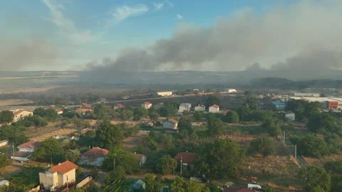 Aerial view of dangerous fire in the forest close to highway and village. 스톡 동영상 294073195