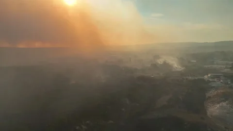Aerial view of dangerous fire in the forest close to highway and village. Stock Footage 294073802