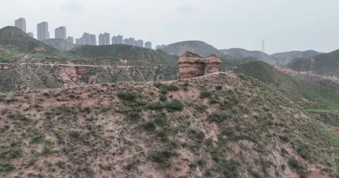 Aerial View Of Danxia Mountain Peak With City Skyline In Distance Vídeos de archivo 312930924