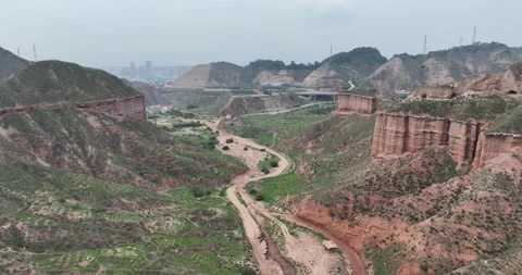 Aerial View Of Danxia Mountains With City Skyline In Distance Vidéo 312930959