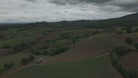 Aerial View of Dark Moody Rolling Hills, Winding Dirt Road and Storm Clouds.. Stock Footage 337392295