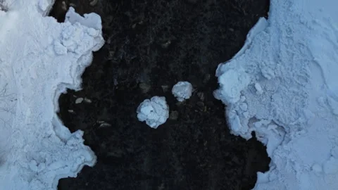 Aerial view of a dark patch in pristine snow, creating a unique winter scene Vídeos de archivo 300116918