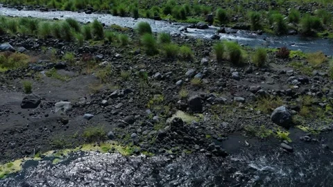 Aerial view of dark rocks line in a flowing river. Ideal for nature concepts Stock Footage 336854492