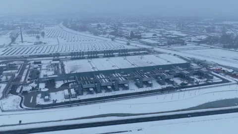 Aerial view of data center and solar panel farm during winter Stock Footage 327904211