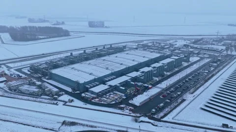 Aerial view of data center building during winter snowfall Stock Footage 327904232
