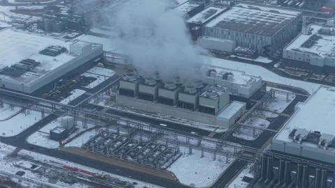 Aerial view of data center cooling system emitting steam in winter Stock Footage 327904395