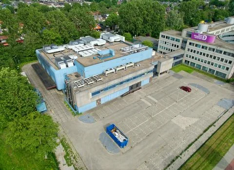 Aerial view of data center with rooftop cooling units and parking lot Stock Photos