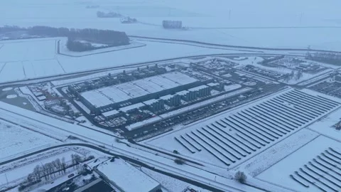 Aerial view of data center with solar panels in winter snowfall Stock Footage 327904486