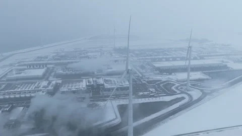 Aerial view of a data center with wind turbines in a snowy winter landscape Stock Footage 327904291